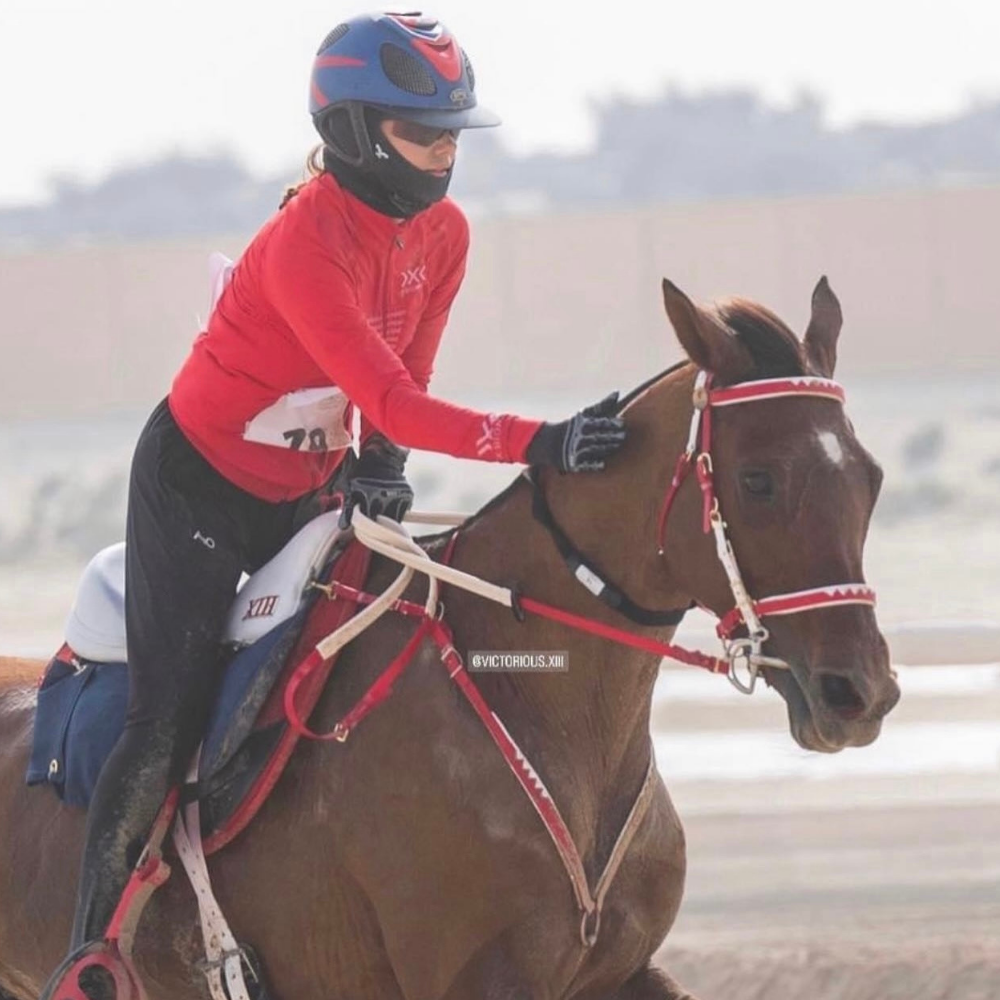 N1 RIDING MASK being used by a rider in training on a horse at an equestrian venue.