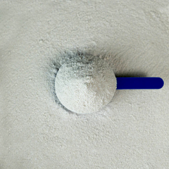 Tendon-Care supplement scoop filled with powder on a light surface for healthy equine tendons.