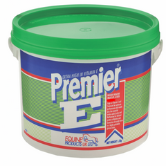 A container of Premier E, a vitamin E supplement for horses, with a green lid and a label featuring the brand name and product information.