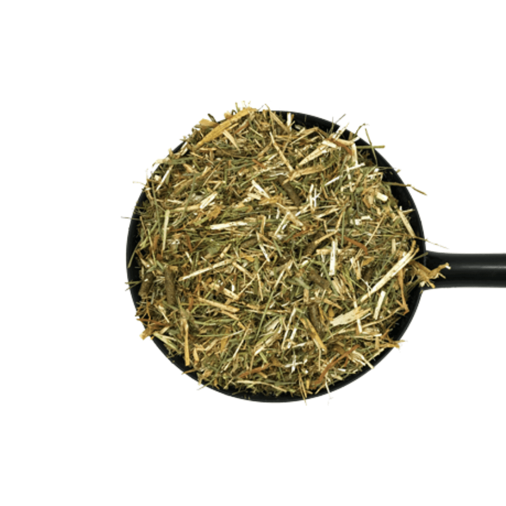 SAFE AND SOUND-D&H UK Daily Fibre Horse Feed in a scoop filled with dried grass and fiber.