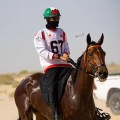 A1F Adventure Riding Mask worn by a rider in white jersey 67 on a horse in a desert setting.