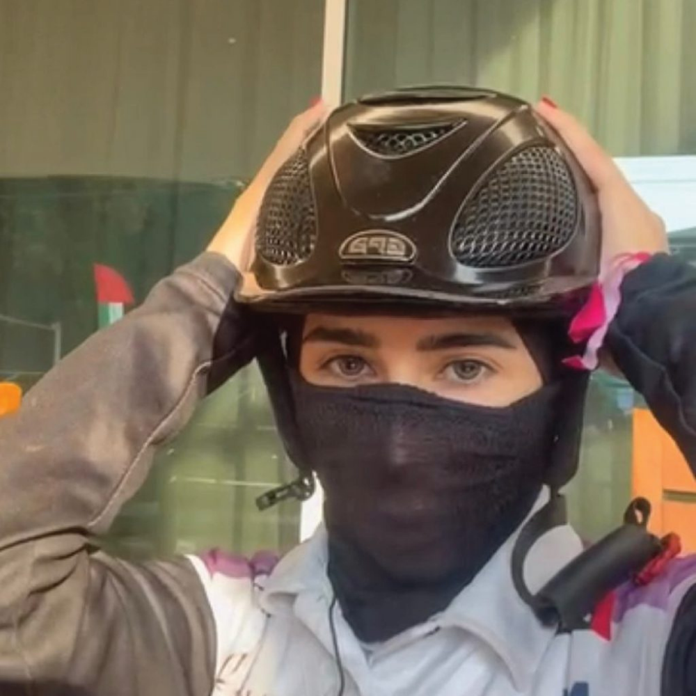 A1F Adventure Riding Mask worn by a rider adjusting their helmet outdoors.