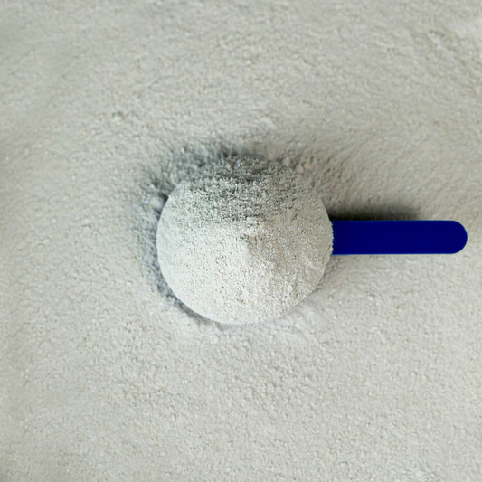 Tendon-Care supplement scoop filled with powder on a light surface for healthy equine tendons.