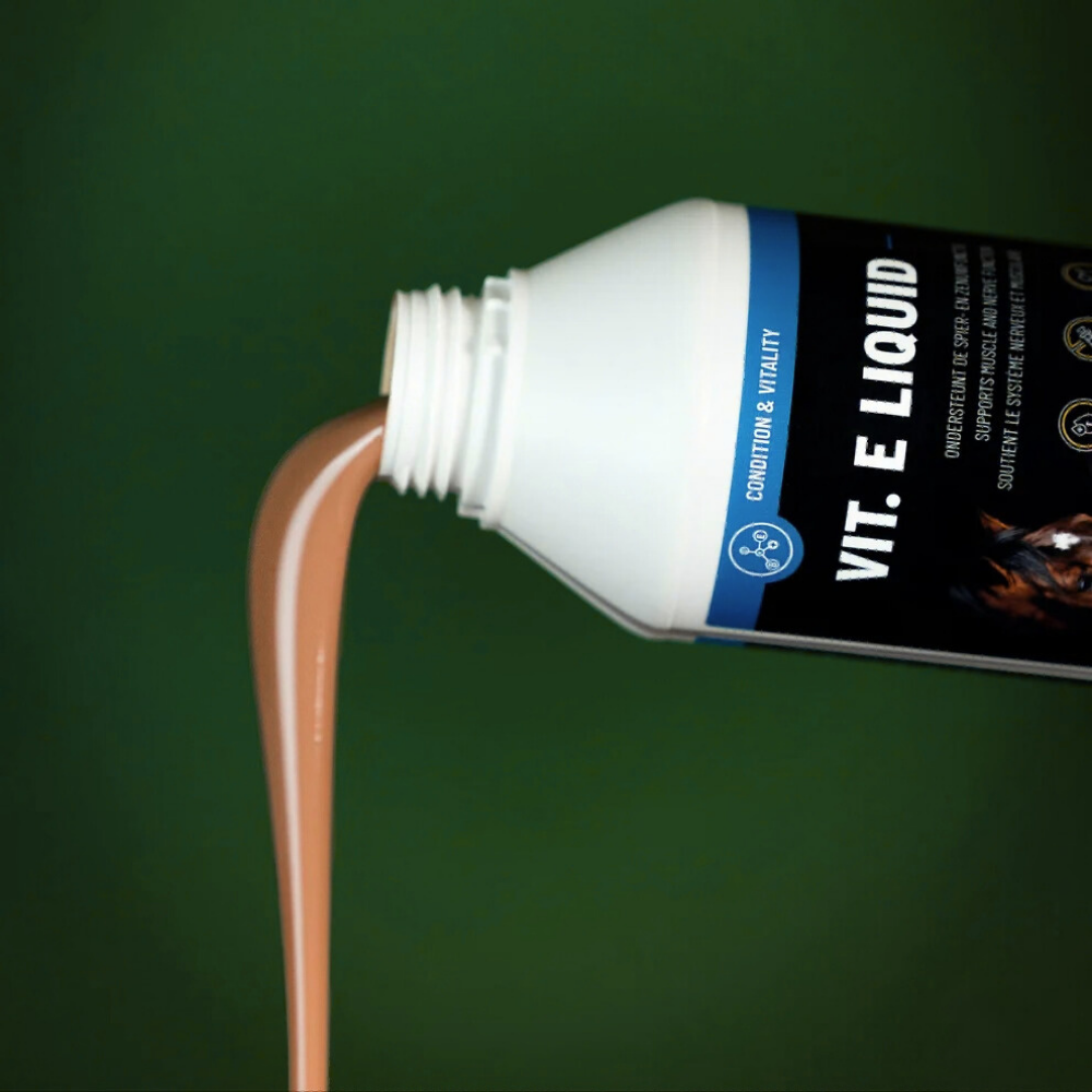 Bottle of VIT. E LIQUID pouring for muscle and nerve support in horses.