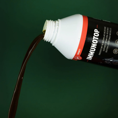 Bottle of Immunotop pouring liquid, showcasing natural immunity support for horses.