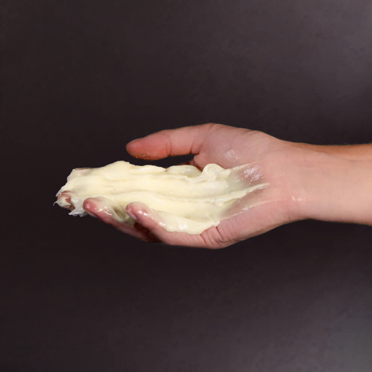A hand holding a creamy skin repair product, related to DERMA PRO skin repair and protection.