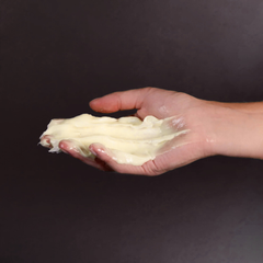 A hand holding a creamy skin repair product, related to DERMA PRO skin repair and protection.